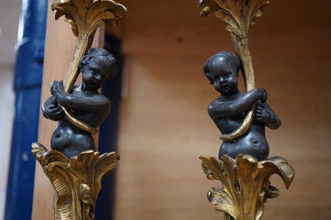 A pair of decorative French ormolu figural candlesticks, 25.5cm high